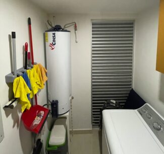 Natural draft gas water heater with no flue for exhaust gases.