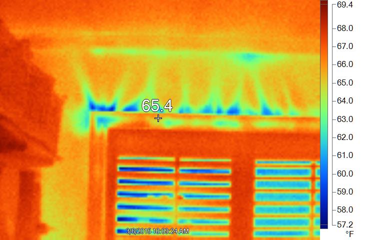 Infrared image of heat loss around window due to air leakage, with blower door running